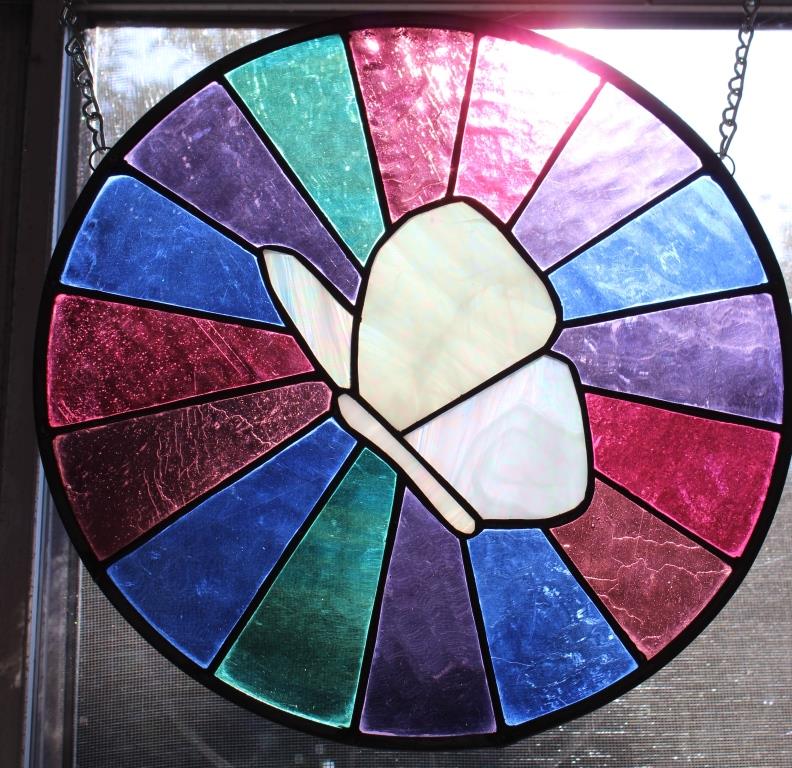 circular stained glass, white butterfly with radiating colors
