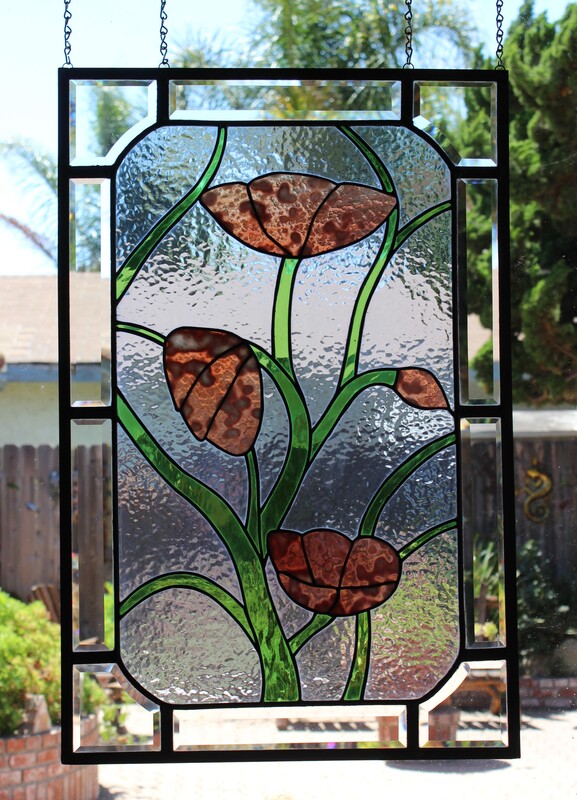 large stained-glass panel, vines and pink flowers