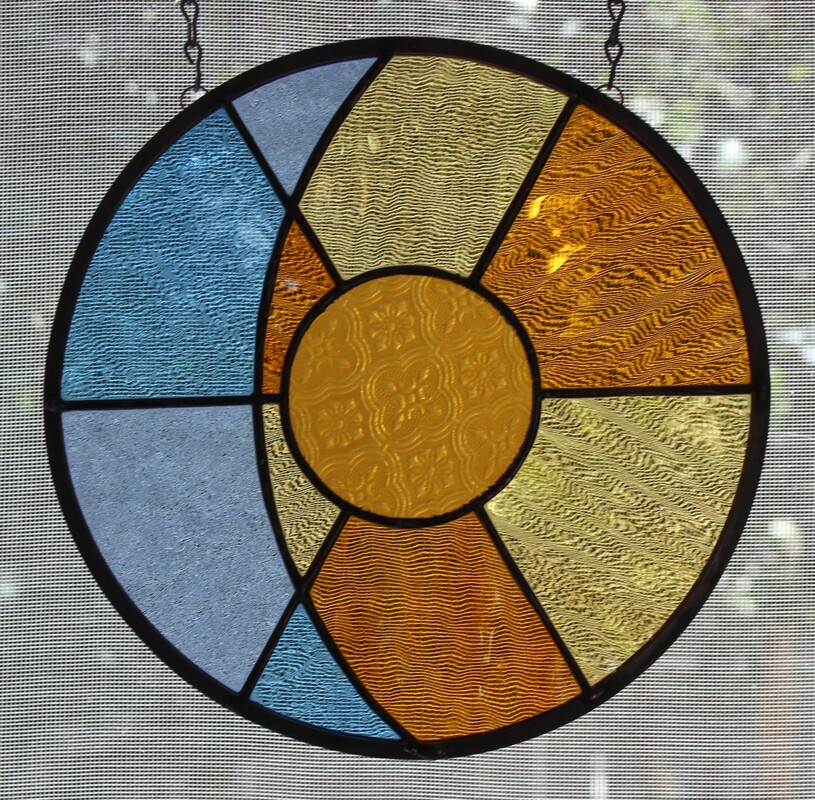 Overlaid sun and moon, circular stained glass 