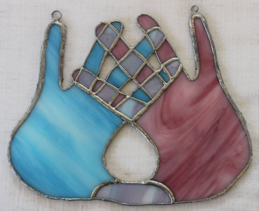 Blue and pink hands, freeform stained glass 