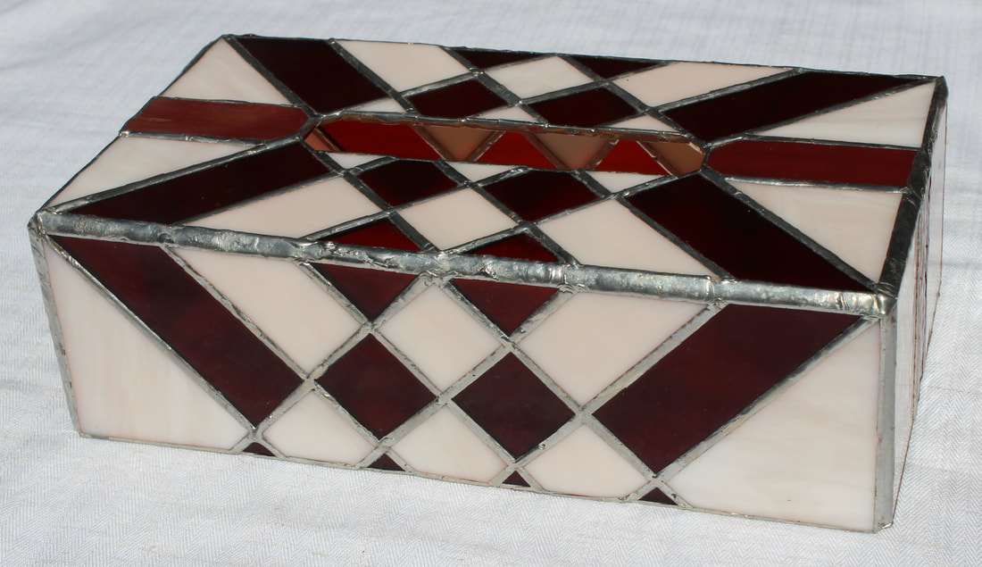 Rectangular stained-glass tissue box with red and pink squares 
