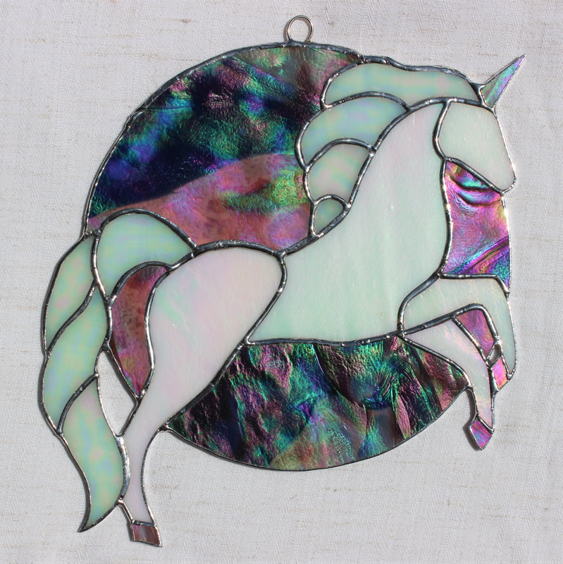 Iridescent unicorn rearing in front of indigo moon
